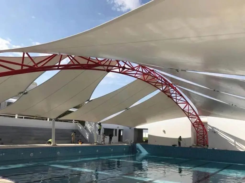 Structural steel arch truss pool shade structure