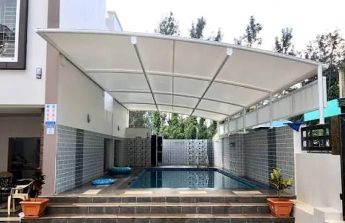 Poolside sun sail shade over luxury recreation area