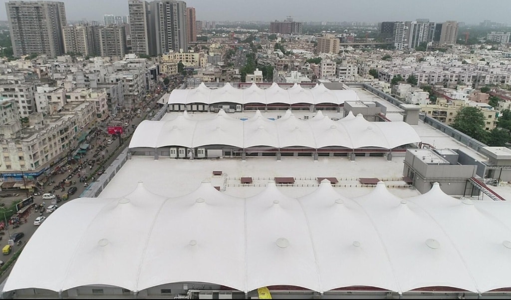 Expansive multi-cone architectural tensile roof structure over commercial building