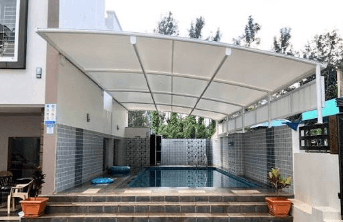 Poolside sun sail shade over luxury recreation area