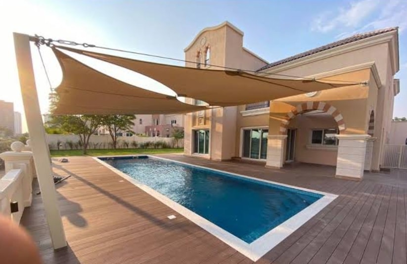 Modern residential villa swimming pool with dual tensile sun sails