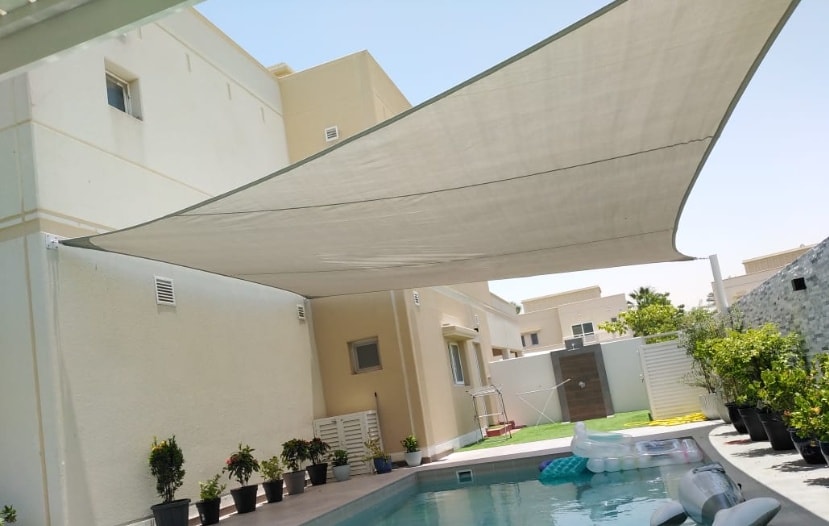 High-tension tensile shade sail over private villa swimming pool