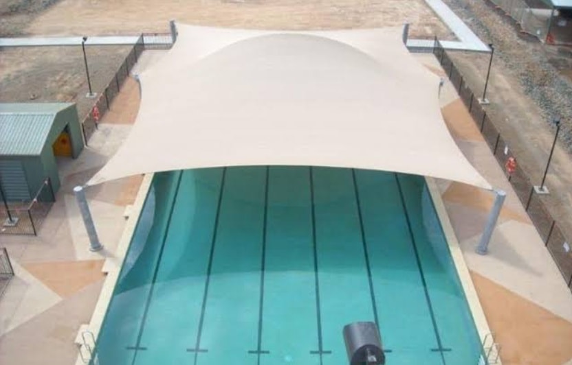 High-span architectural tensile membrane roof over swimming pool lanes
